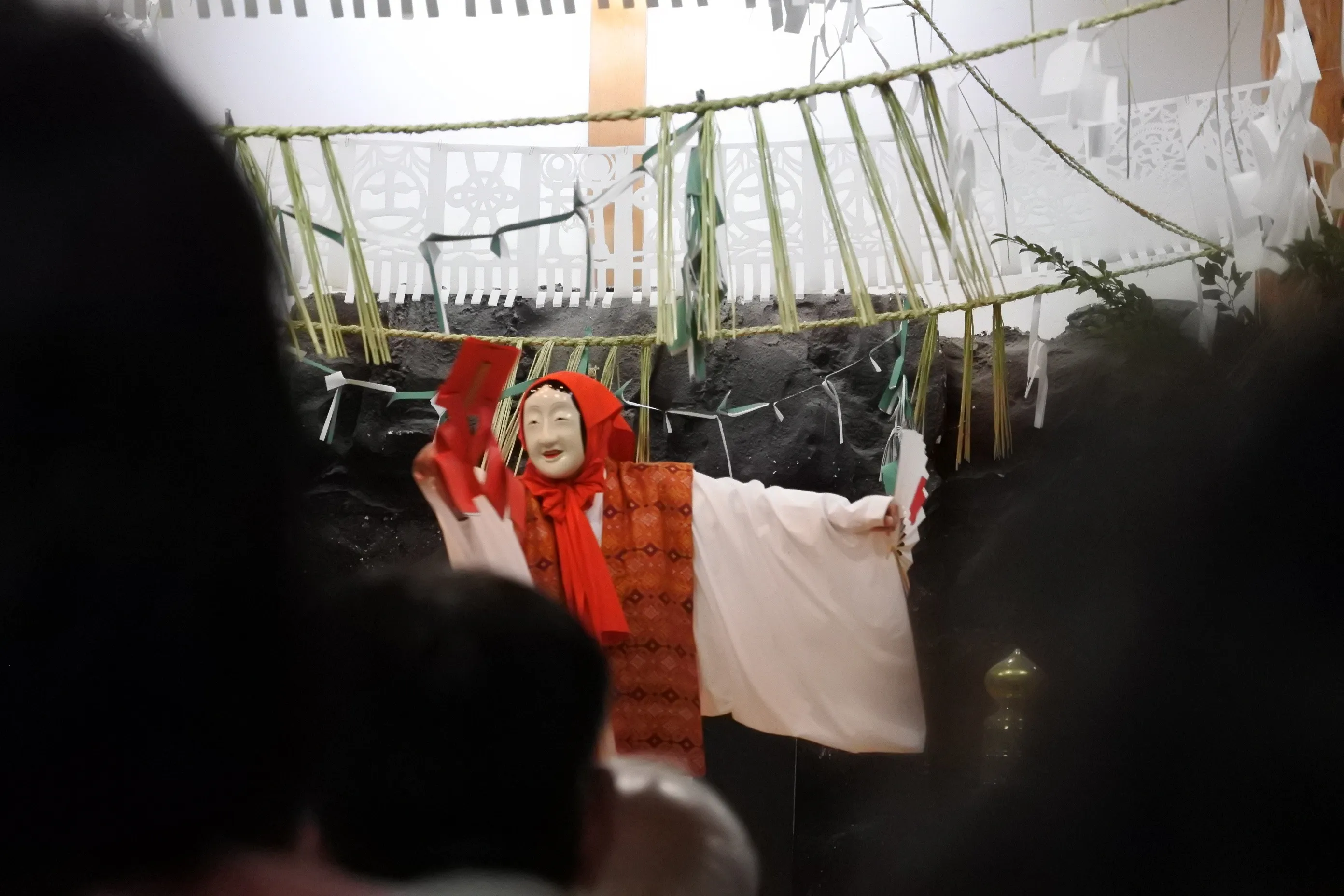 Kagura performer with white mask