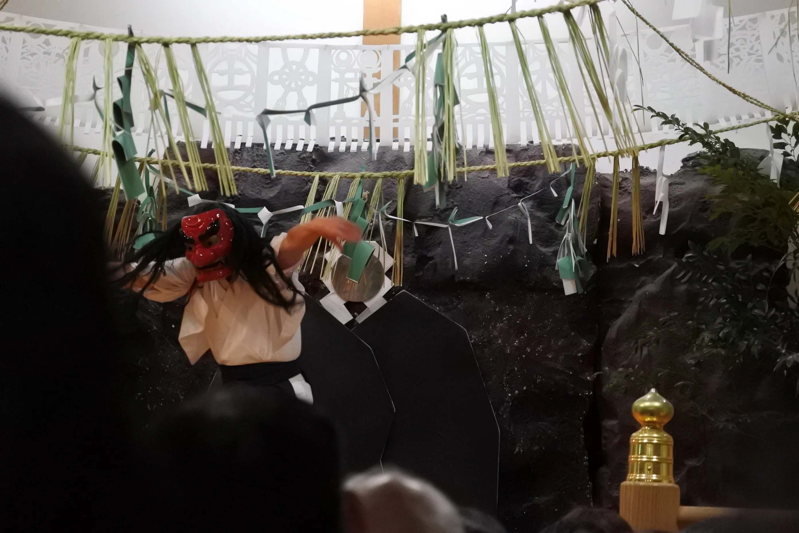 Kagura performer with red oni mask